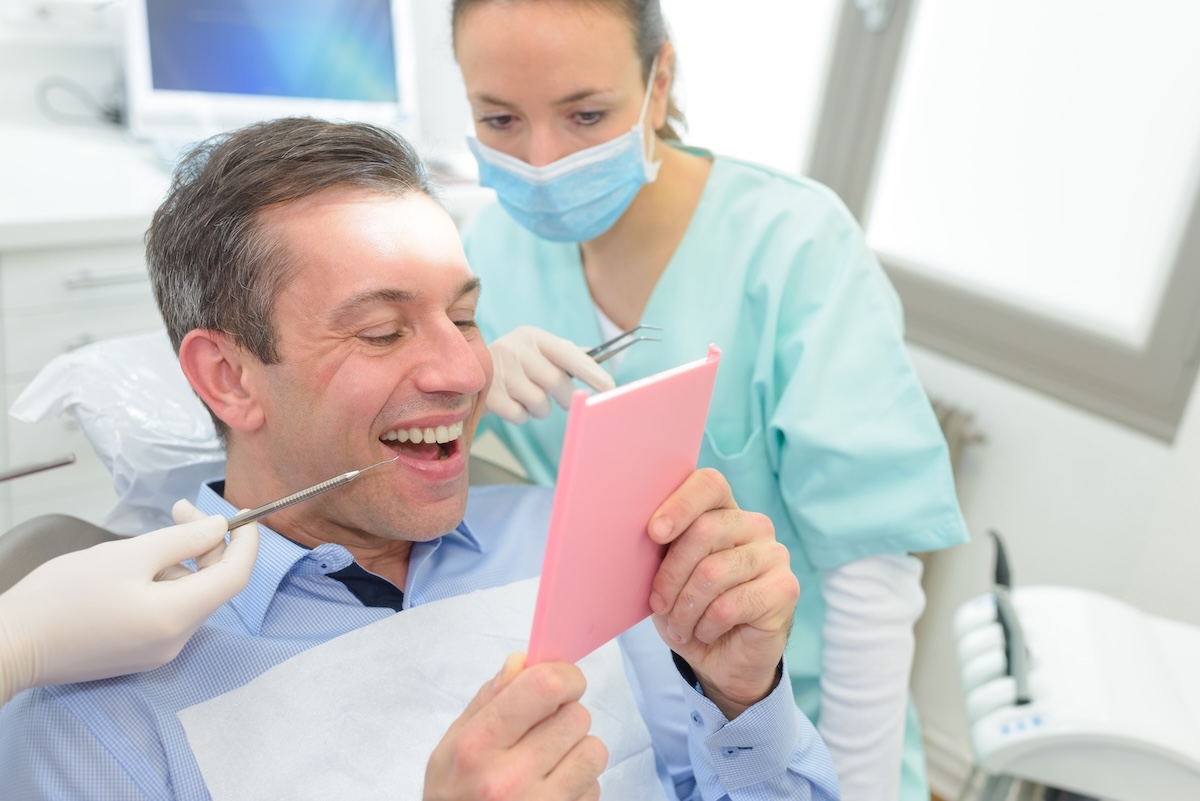 man with dental mirror